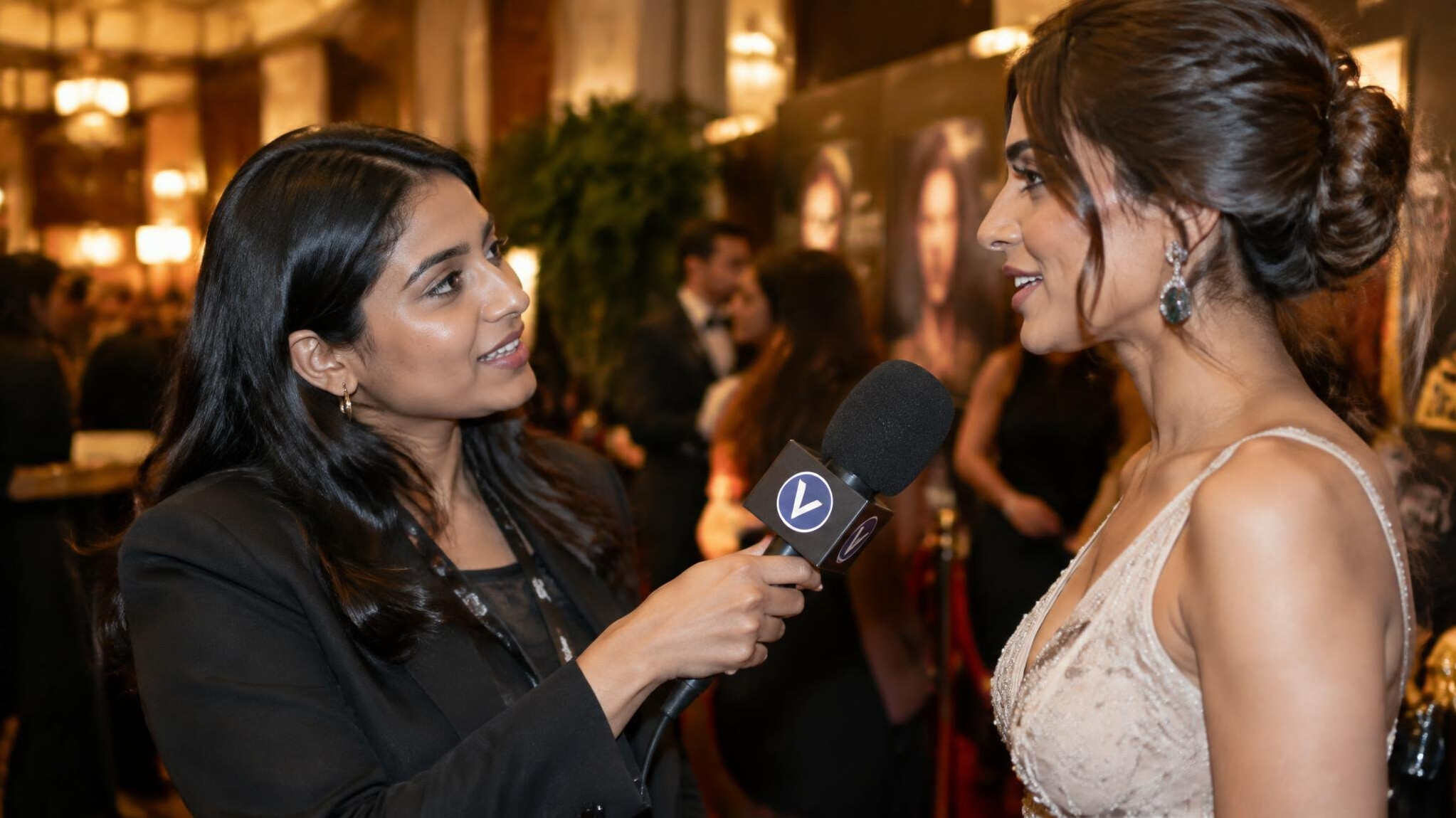 Journalist holding a microphone during a red carpet interview