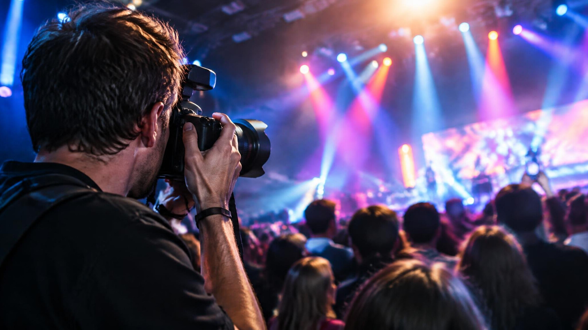 Photographer capturing a crowd at a live entertainment event