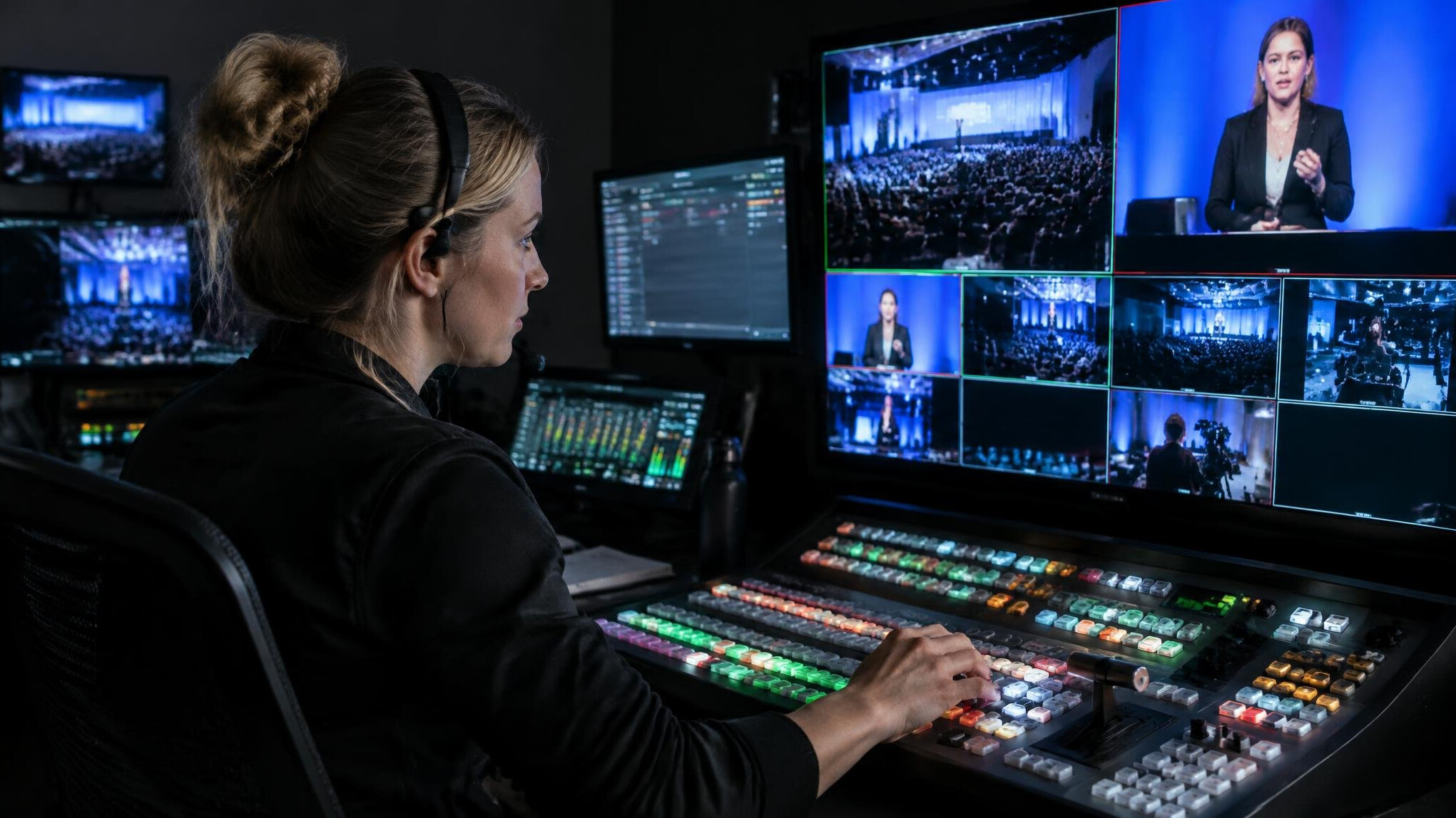 Technician configuring multiple camera angles at a control monitor